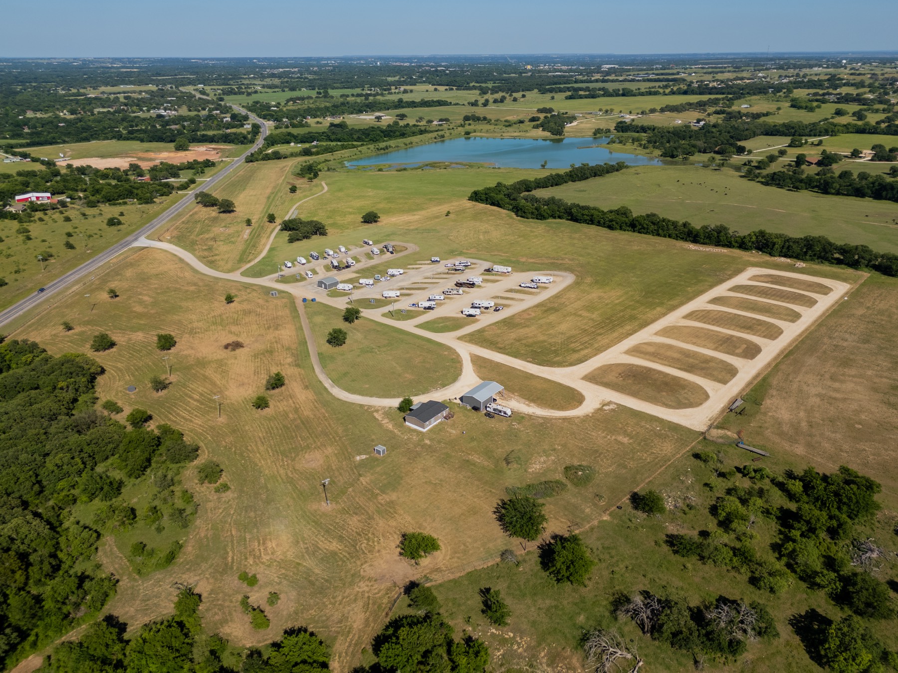 Aerial view of Stephenville RV Park — sites, facility, and the reservoir beyond